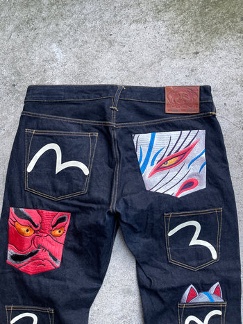 EVISU 2010 MULTI POCKET EMBROIDERED FACES SELVEDGE DENIM JEANS