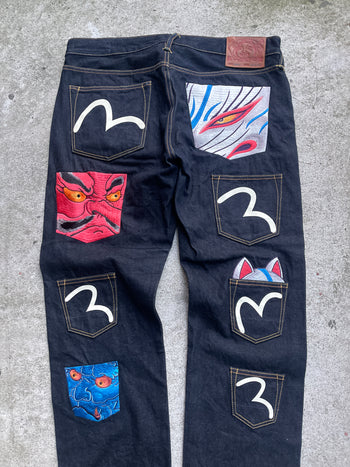 EVISU 2010 MULTI POCKET EMBROIDERED FACES SELVEDGE DENIM JEANS