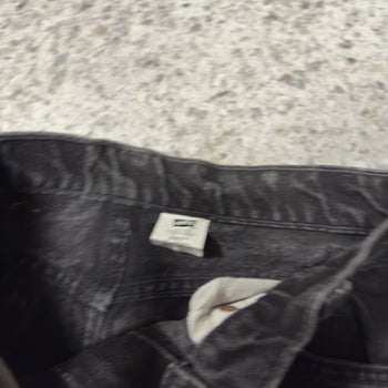 Vaqueros Levi's 550 con lengüeta naranja y negro descolorido de los años 90