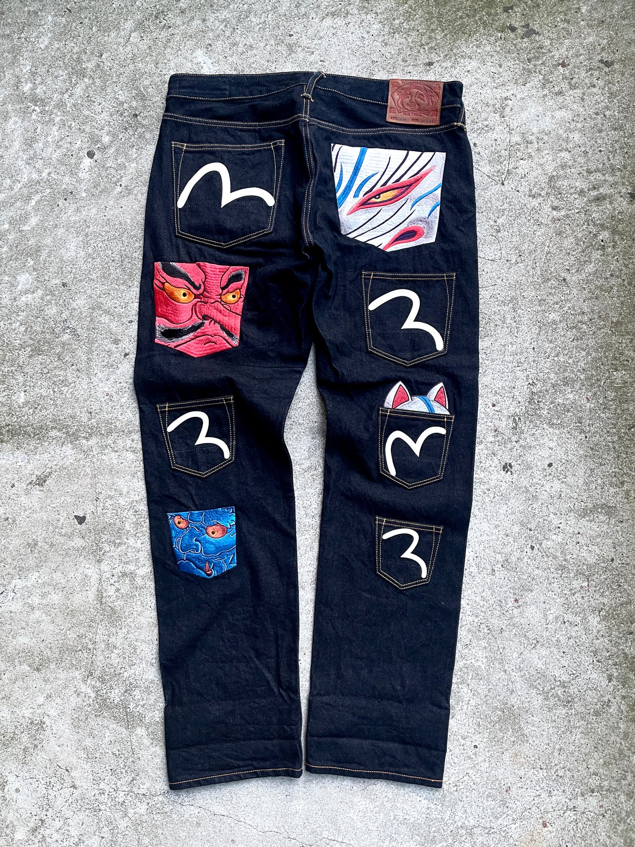 EVISU 2010 MULTI POCKET EMBROIDERED FACES SELVEDGE DENIM JEANS