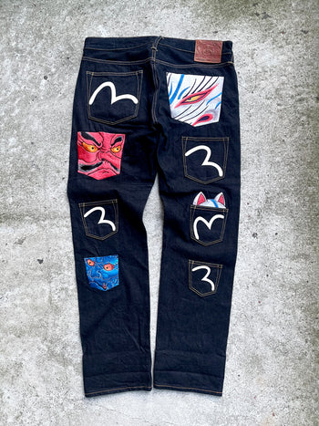 EVISU 2010 MULTI POCKET EMBROIDERED FACES SELVEDGE DENIM JEANS