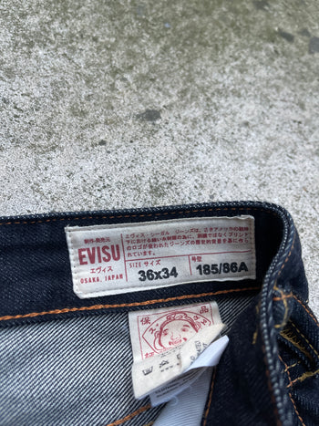EVISU 2010 MULTI POCKET EMBROIDERED FACES SELVEDGE DENIM JEANS